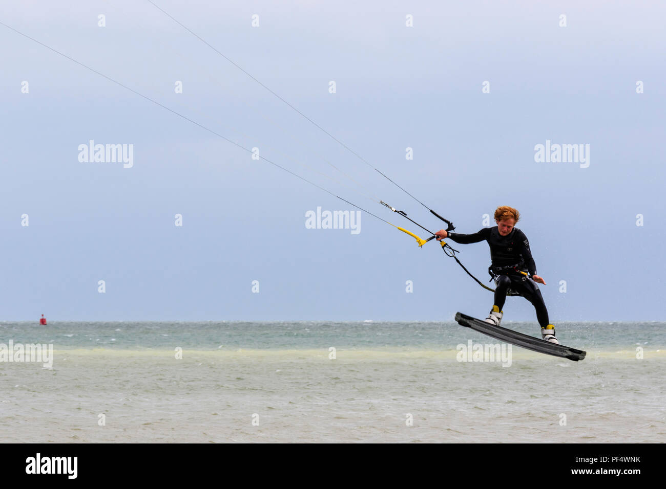 National freestyle Kiteboarding Championships at Ramsgate. Man kiteboarding, jumping and flying