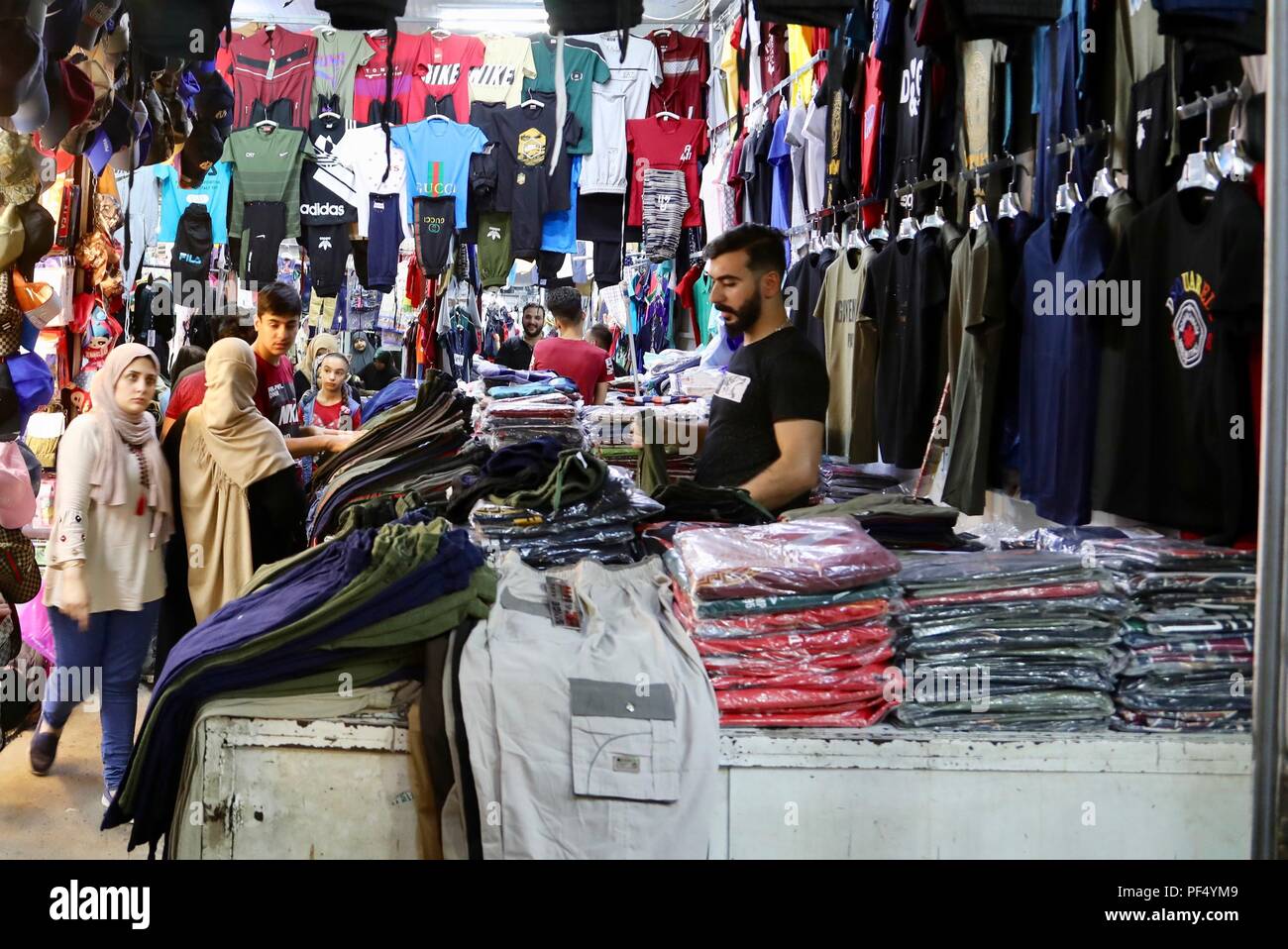Baghdad, Iraq. 19th Aug, 2018. Iraqi people shop at a local market in  Mansour, western Baghdad, Iraq, on Aug. 19, 2018, ahead of the annual  festival Eid al-Adha, which begins on Aug.
