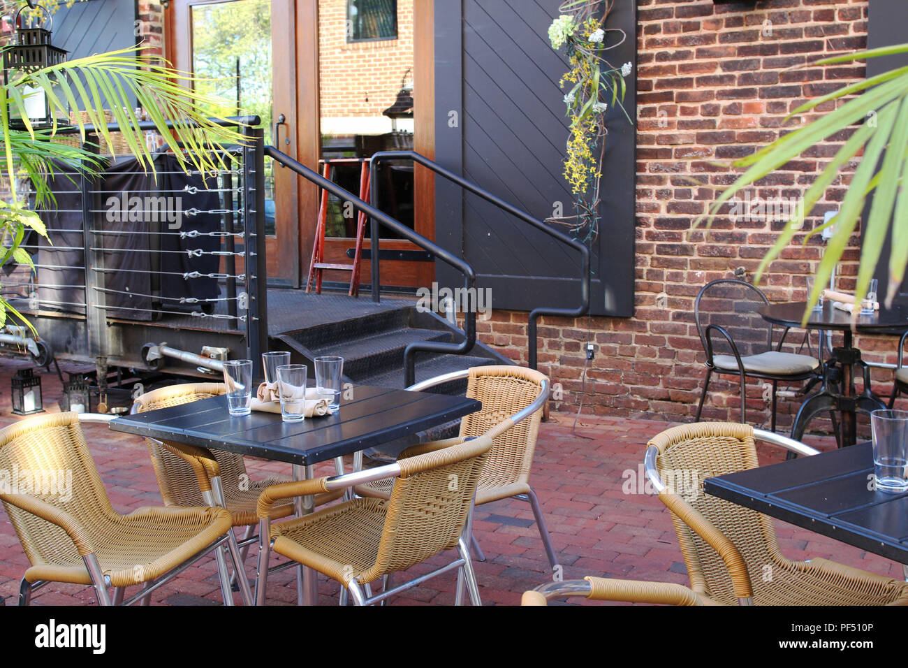 Tables with chairs at an open air cafe with no visitors, Old Town Alexandria, Virginia Stock Photo