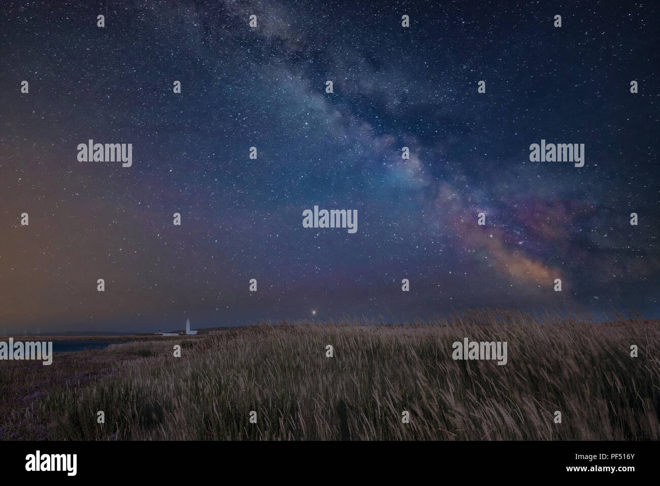 Stunning vibrant Milky Way composite image over landscape of Lighthouse ...