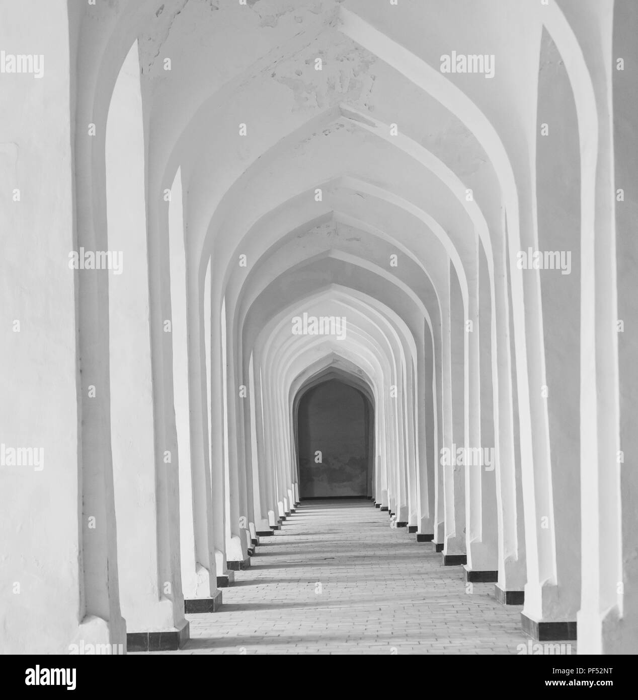 White Arabian arches in Kolon mosque. Bukhara. Uzbekistan. Central Asia. Stock Photo