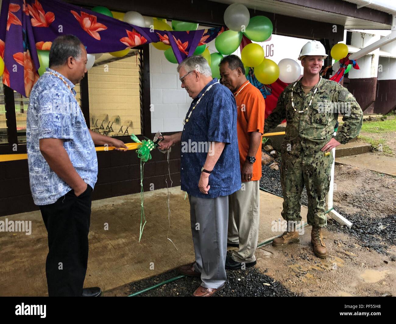 180809-N-HG710-2216 CHUUK, Federated States of Micronesia (August 9th, 2018) Graceful Enlet, Director of the Chuuk Department of Education, left, Theodore Pierce, Deputy Chief of Mission U.S Embassy to the Federated States of Micronesia (FSM), center left, Ignacio Stephen, Chuuk Government Chief of Staff, center right, and Builder Chief John Watters, assistant officer in charge, Construction Civic Action Detail (CCAD) FSM, cut the ribbon for the Two-Room Classroom project at Chuuk High School in Weno, Chuuk, officially signifying the opening of the building. NMCB-11 is forward deployed to exec Stock Photo