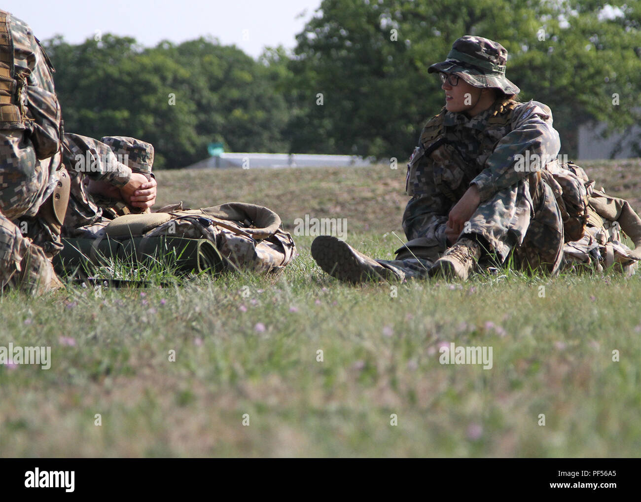 CAMP GRAYLING, Mich. - Pvt. Laura Bračka with the 36 KAB (Combat Support Battalion) of Latvia waits for a U.S. Army UH-60 Blackhawk helicopter at Camp Grayling, Mich., on Aug. 11, 2018. Latvian Forces are participating in Northern Strike, a joint multinational combined arms live fire exercise involving approximately 5,000 service members from 11 states and six coalition countries. (U.S. Army National Guard photo by Pfc. Jonathan Perdelwitz) Stock Photo