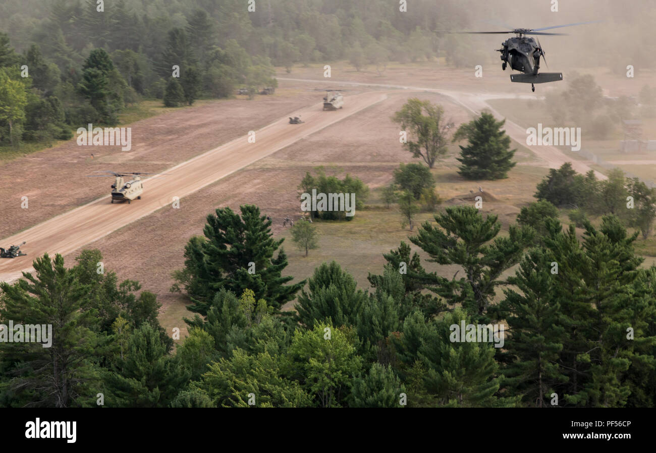 A UH-60 approaches a landing strip after assisting with a sling load operation involving an M777 Howitzer during Northern Strike at Camp Grayling, Mich., on Aug. 10, 2018. Northern Strike is a joint multinational combined arms live fire exercise involving approximately 5,000 service members from 11 states and six coalition countries. (U.S. Army National Guard photo by Sgt. Tawny Schmit) Stock Photo