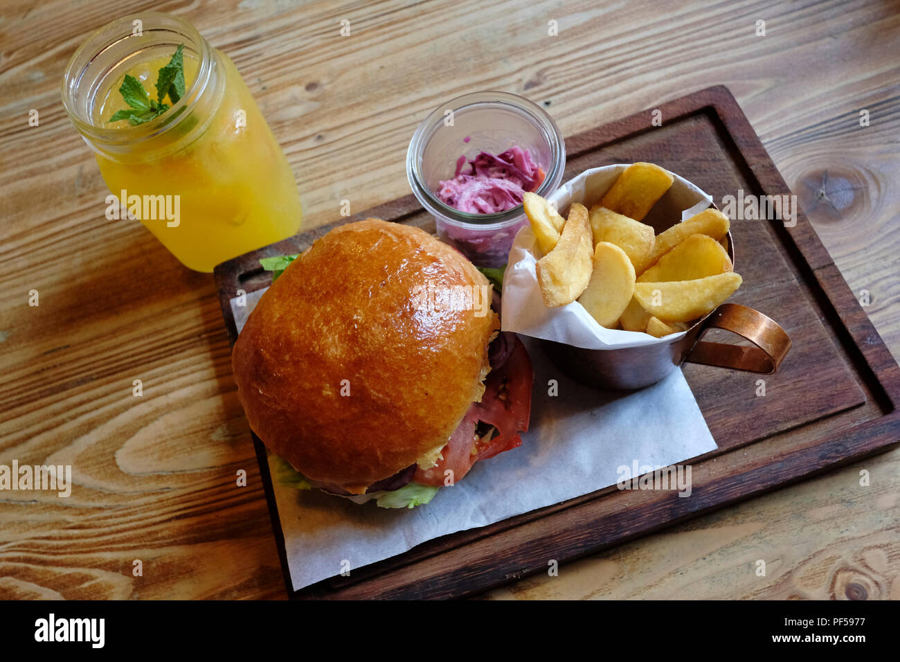 A dish of burger served with chips at Stol i Wolmeat meat restaurant in the  old town in the city of Lublin Eastern Poland Stock Photo - Alamy