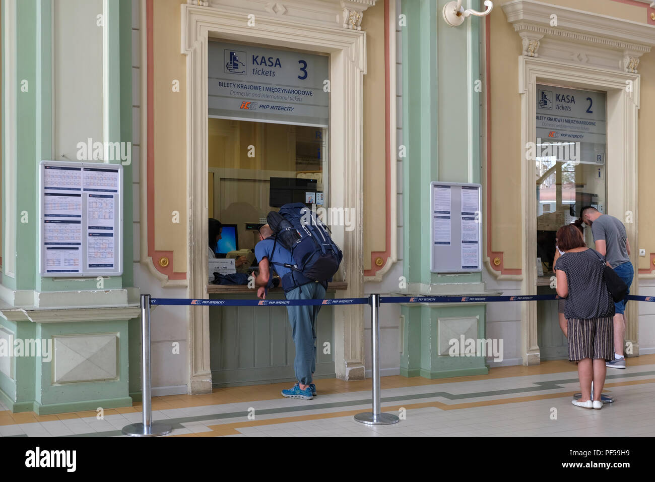 Passengers queuing to buy tickets at the train station in the city of Przemysl in south eastern Poland Stock Photo