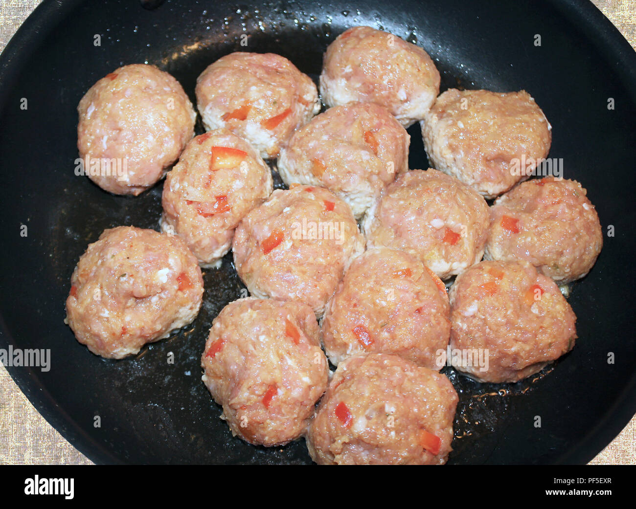 Lean ground turkey meatballs cooking in skillet Stock Photo
