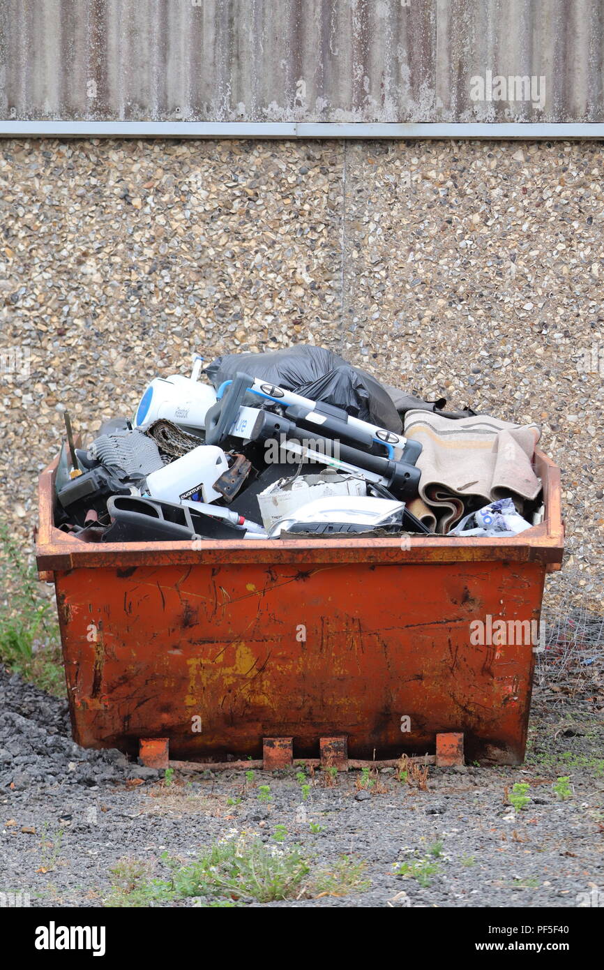 Metal skip container for junk rubbish waste.fill of items no longer