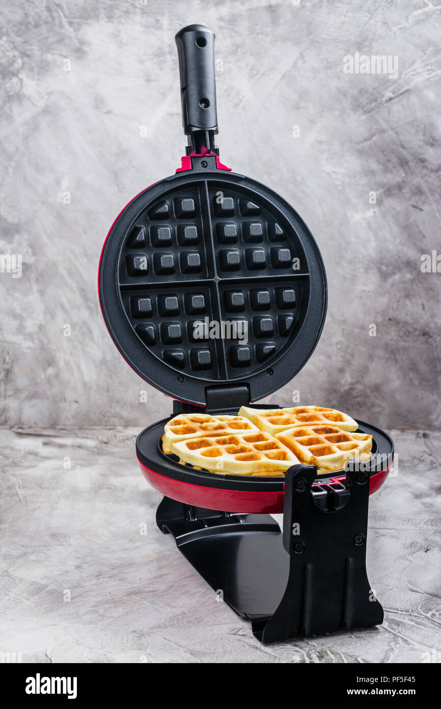 Waffles in an iron waffle maker Stock Photo Alamy