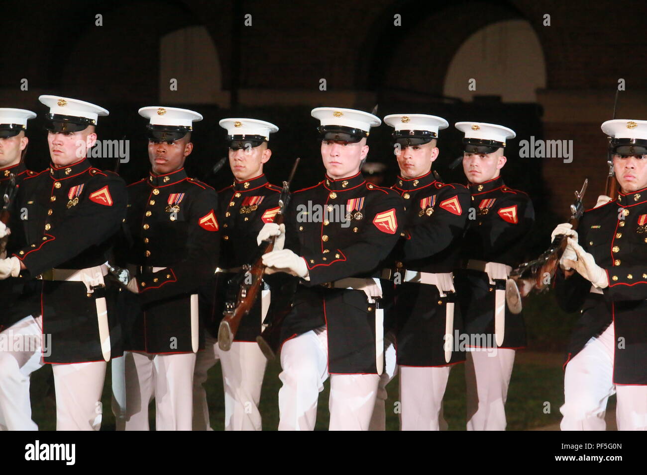 Marines with the U.S. Marine Corps Silent Drill Platoon execute precision rifle drill movements