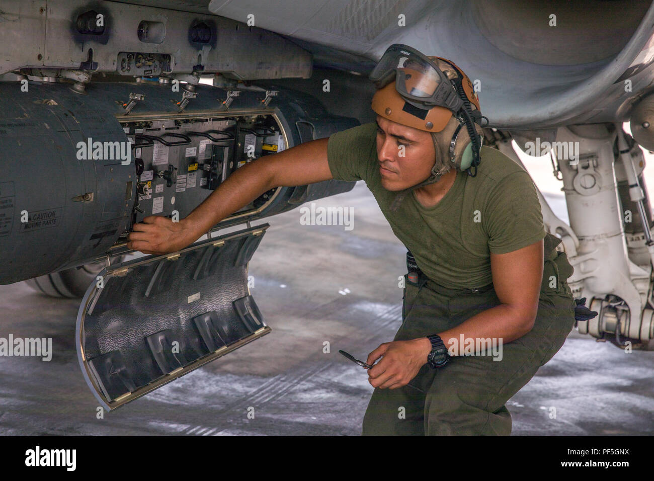 Undisclosed Location, Southwest Asia -- U.s. Marine Corps Lance Cpl. Johnny  Mendez, An Aviation Mechanic With Marine Fighter Attack Squadron 115, Marine  Aircraft Group 31, 2Nd Marine Aircraft Wing, Inspects The Laser
