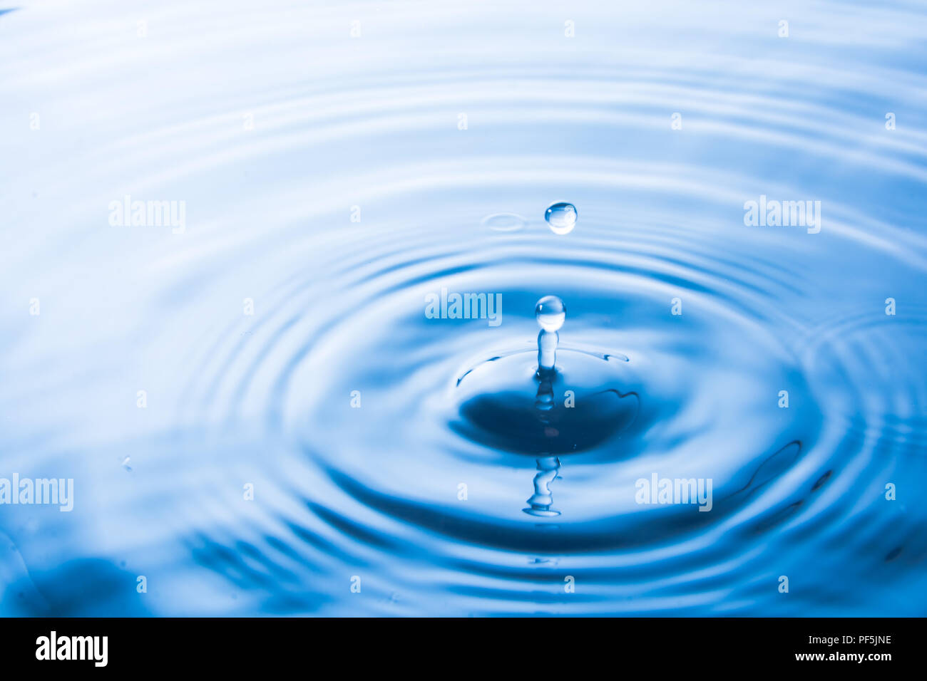 water drop falling into water make waves water splash or water drop background