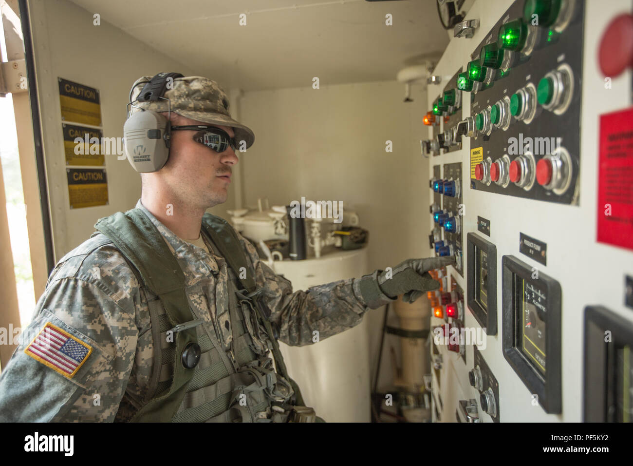 U.S. Army Reserve Spc, Kyle Lee, 651st Quartermaster Company, 79th Sustainment Support Command, Operates the control board of a Reverse Osmosis Water Purification Unit (ROWPU) during Combat Support Training Exercise (CSTX) 86-18-02 at Fort McCoy, Wis., August 15, 2018.  This is the second CSTX of the summer for the 86th Training Division. The CSTX exercise is a large-scale training event where units experience tactical training scenarios specifically designed to replicate real-world missions. (U.S. Army Reserve Photo by Spc. John Russell) Stock Photo