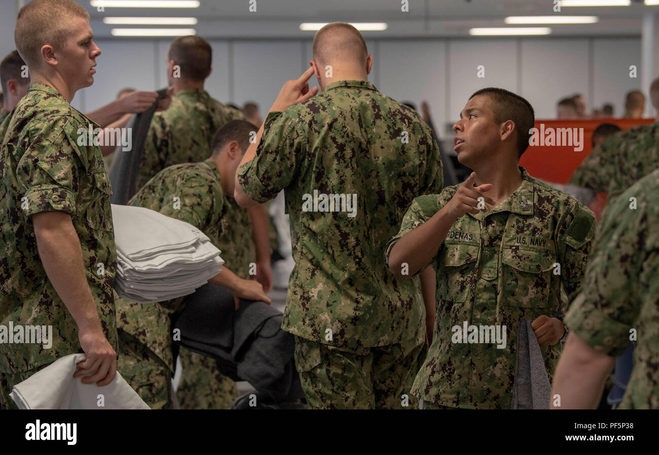 180816-N-PL946-1033 GREAT LAKES, Ill. (Aug. 16, 2018) Recruits pass out  clean linens inside thier compartment at the USS Kearsarge barracks at  Recruit Training Command (RTC). More than 30,000 recruits graduate annually  from
