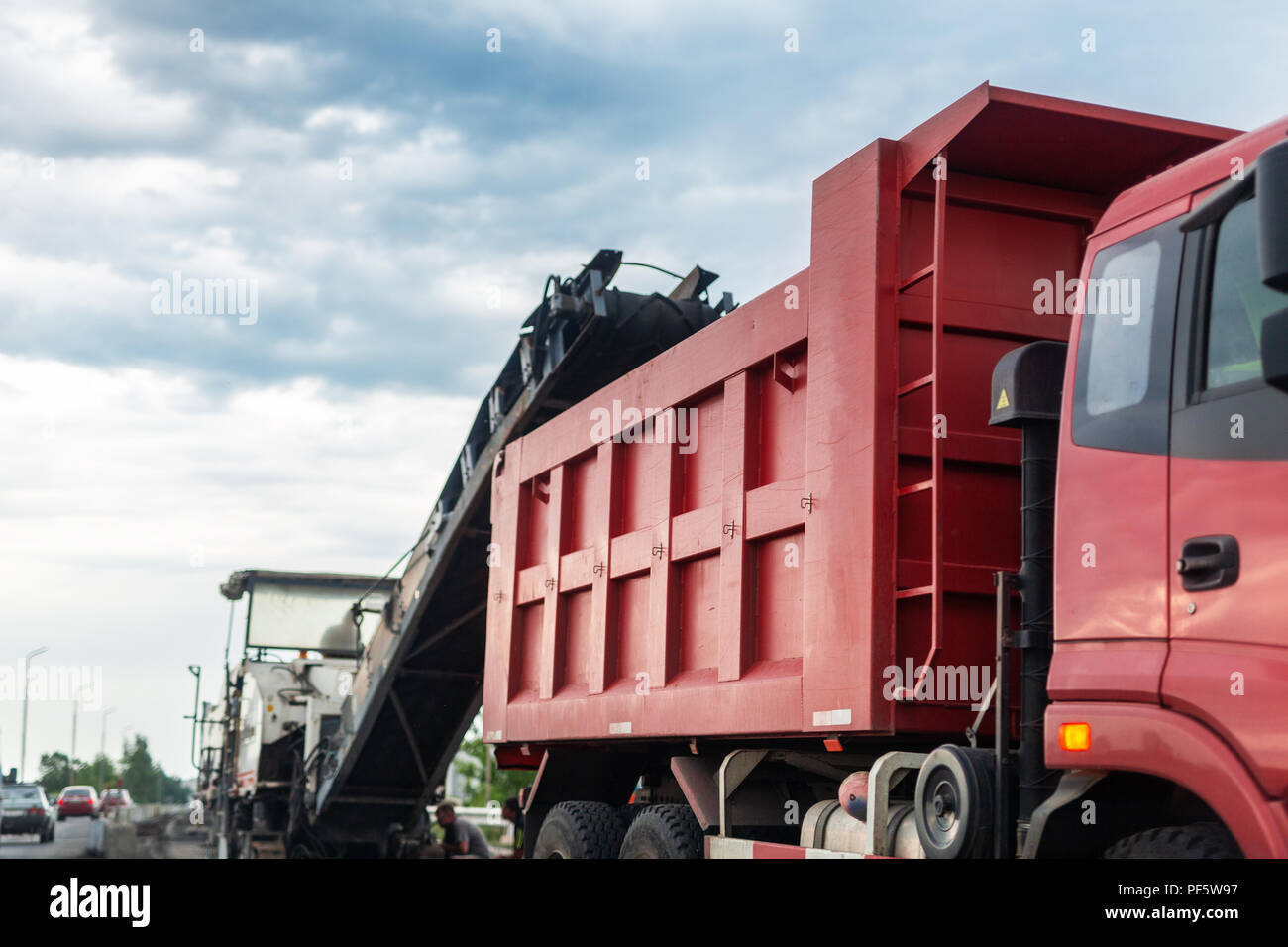 Road construction site. Asphalt milling grinds machine loading used