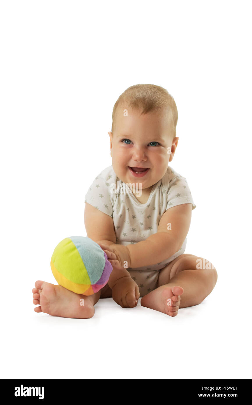 Adorable baby raised the ball above his head. Isolated on white background Stock Photo