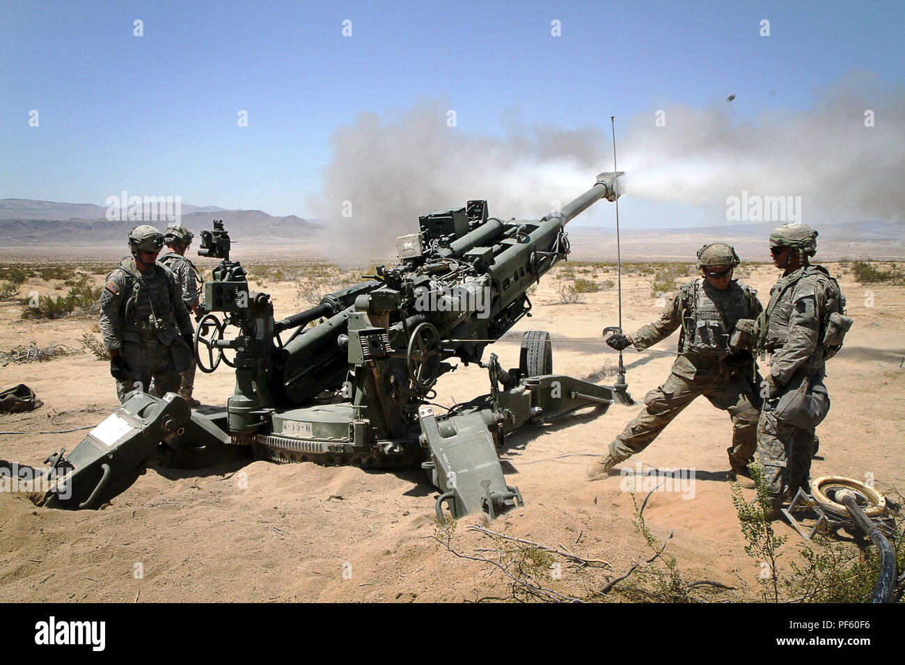 Soldiers of the 1-108th Field Artillery Regiment, 56th Stryker Brigade Combat Team, 28th Infantry Division, Pennsylvania National Guard fire an M777 Howitzer during a live-fire training exercise at the National Training Center, Fort Irwin, California, Aug. 13. (U.S. Army National Guard photo by Cpl. Hannah Baker/released) Stock Photo