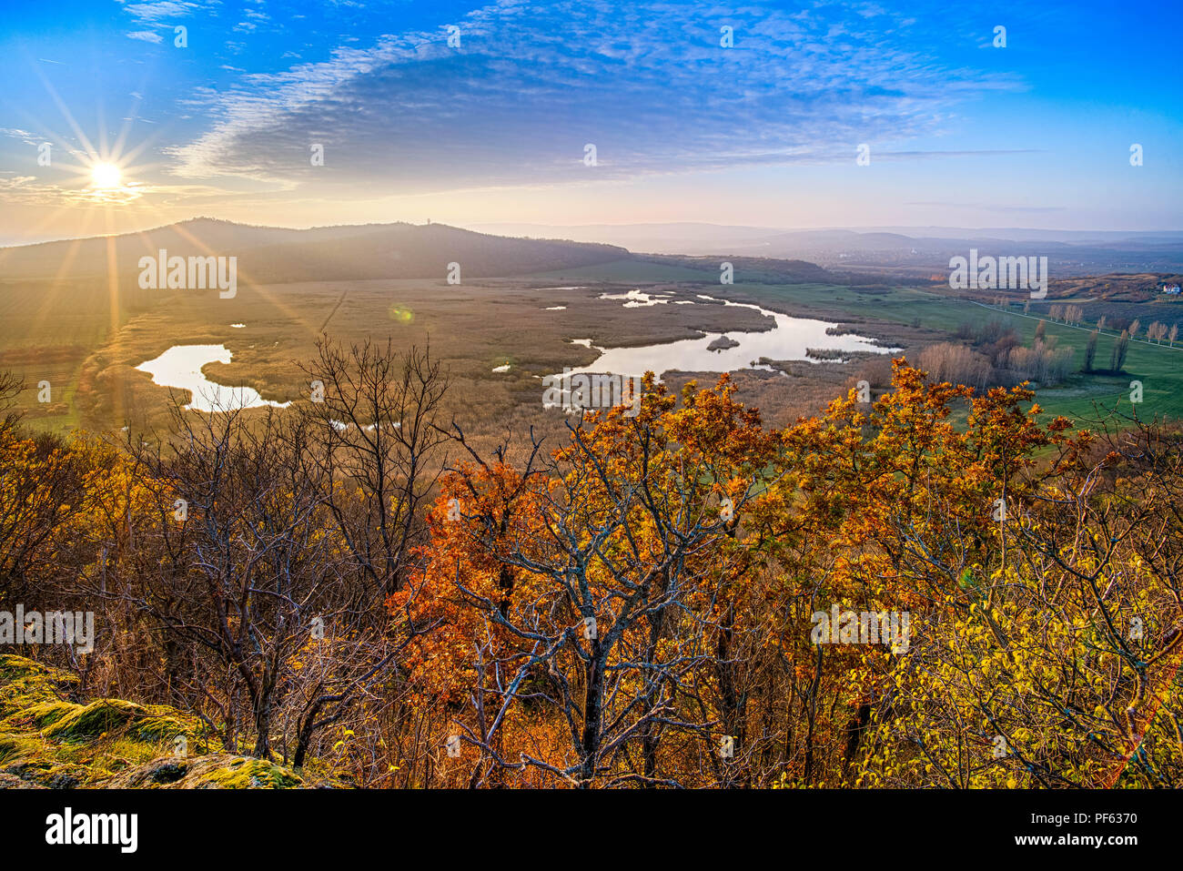 Sun going down over the lake at autumn Stock Photo