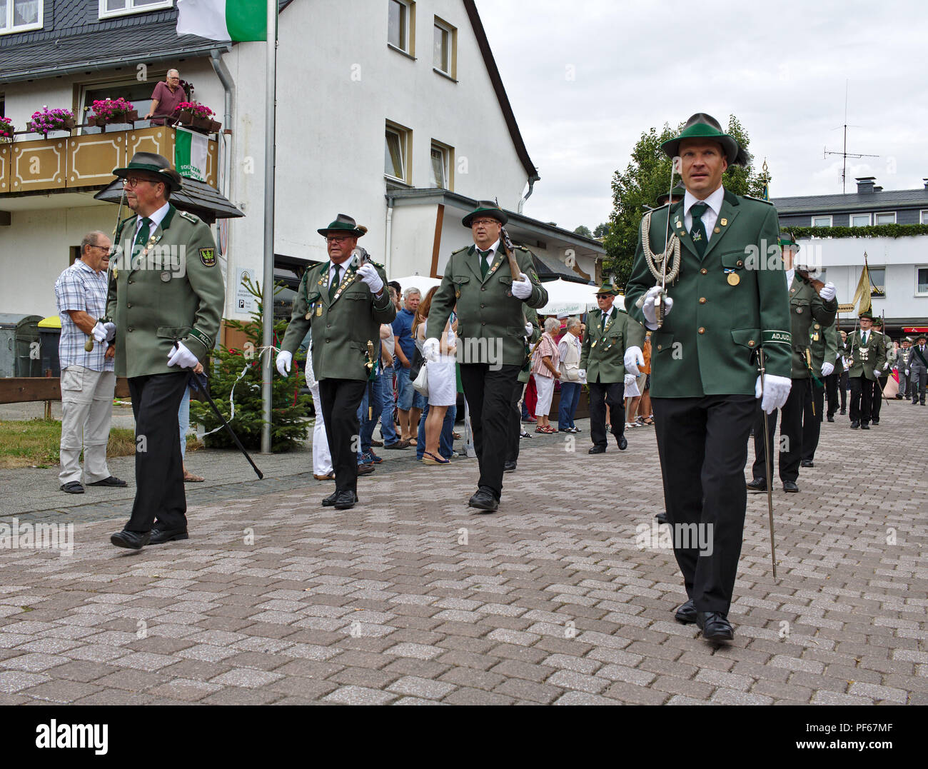Usseln, Germany - July 30th, 2018 - Rifle club members parading in their traditional green uniforms at the marksmen's fair Stock Photo