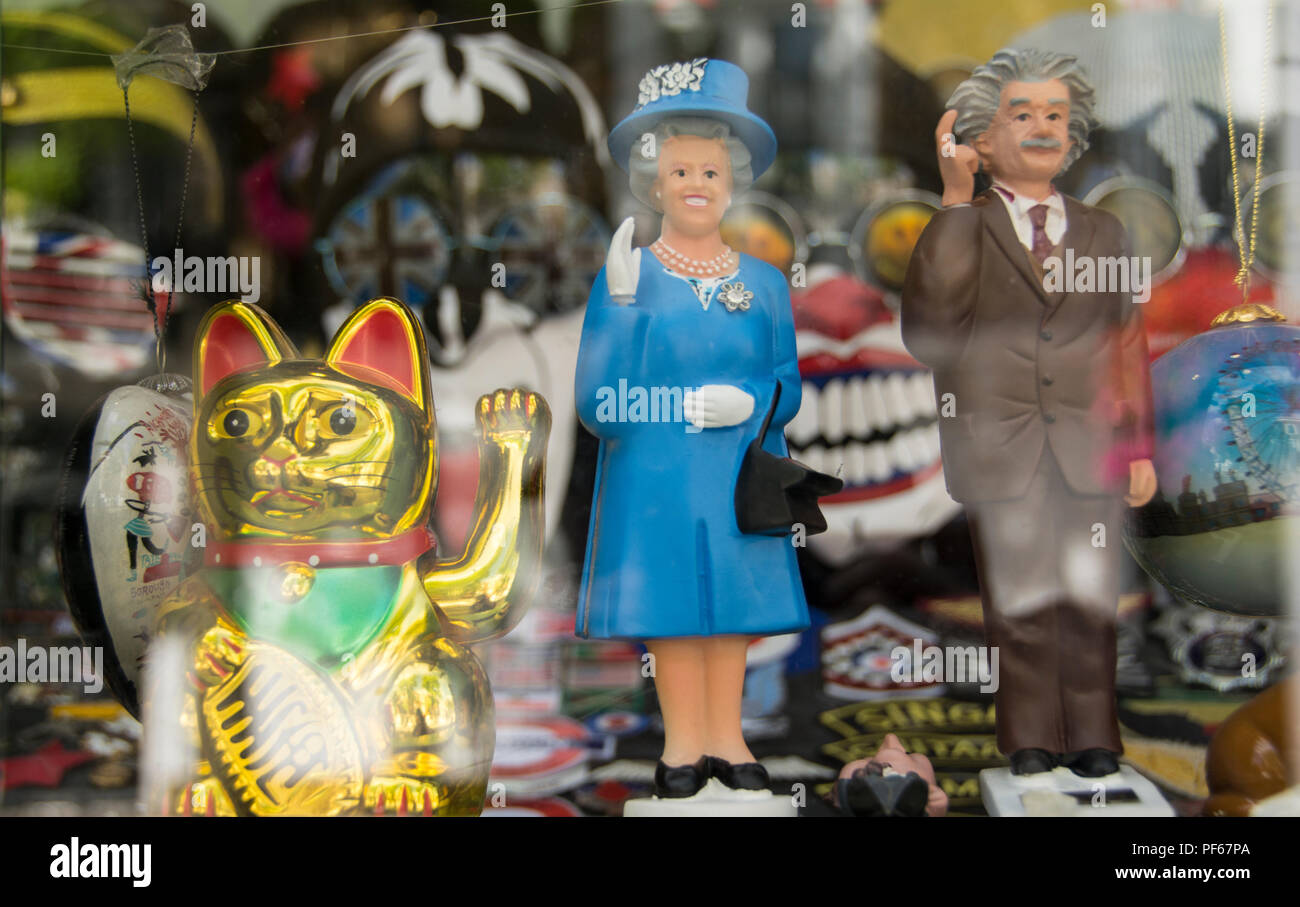 Her Majesty the Queen and Albert Einstein solar powered waving model figurines Stock Photo