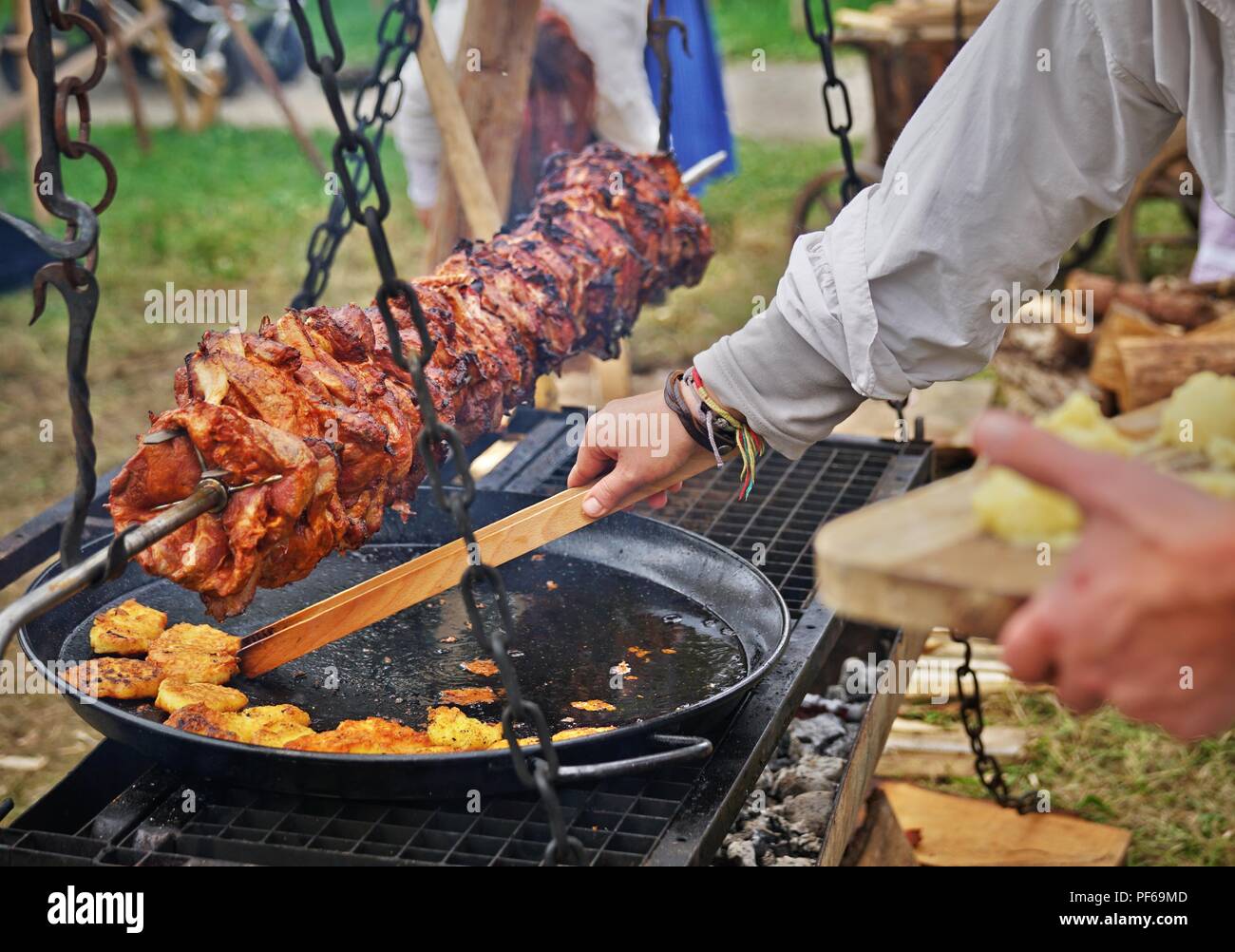 meat roast over a grill with potatos, medieval style Stock Photo