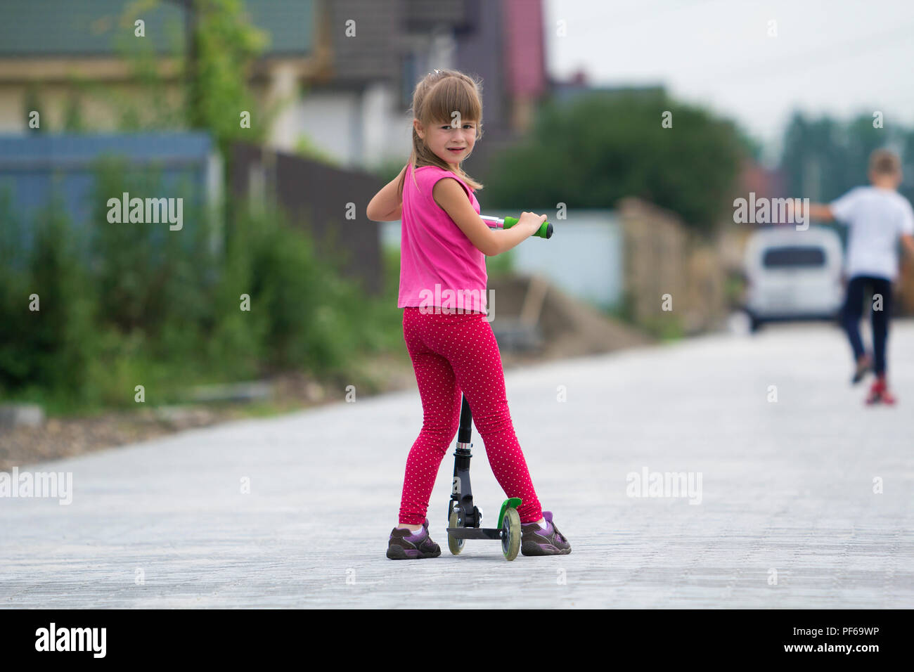 Pretty Young Long Haired Blond Child Girl In Pink Clothing With