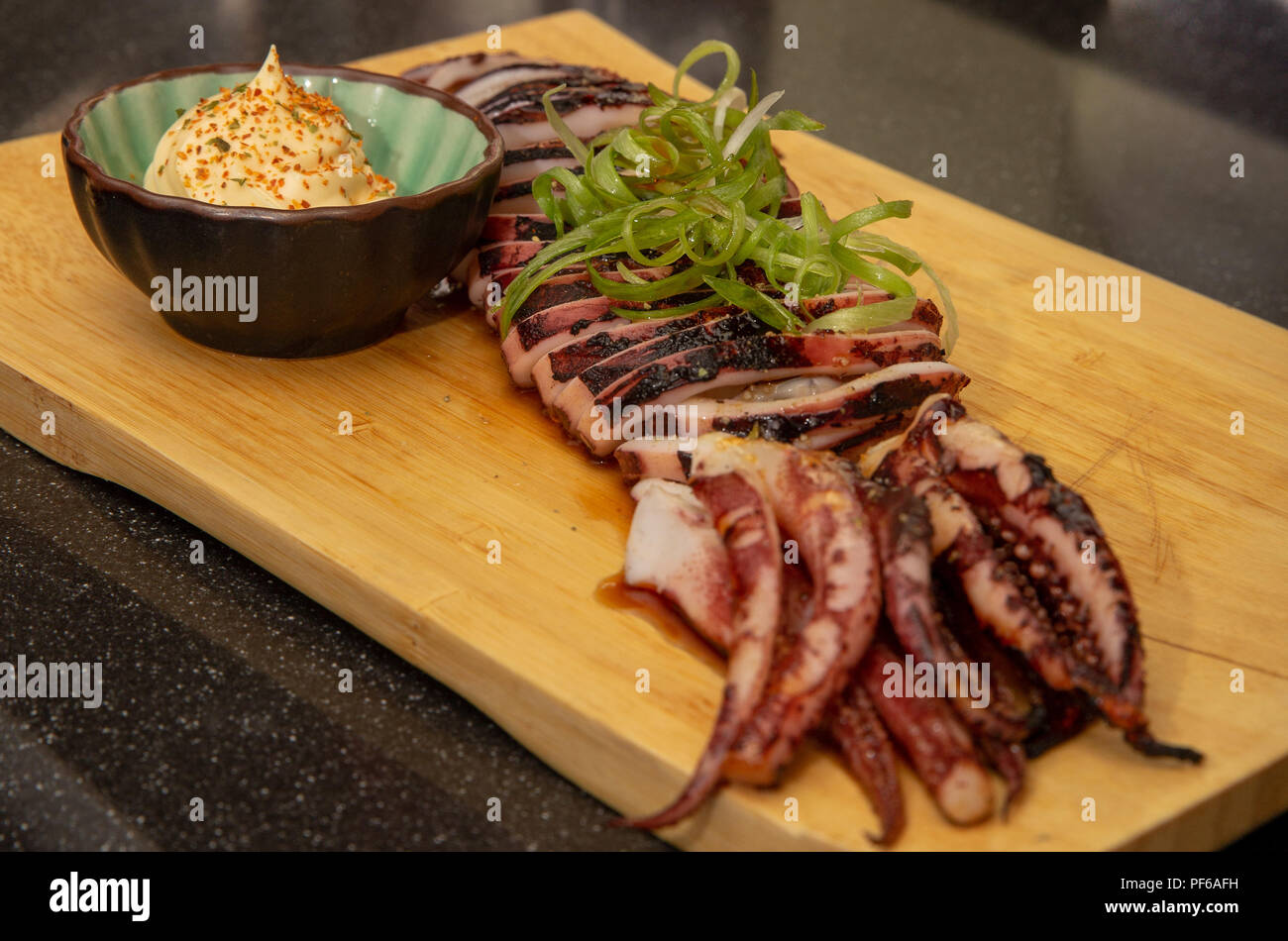 Sliced grilled squid or Calamari at a Japanese restaurant with mayo
