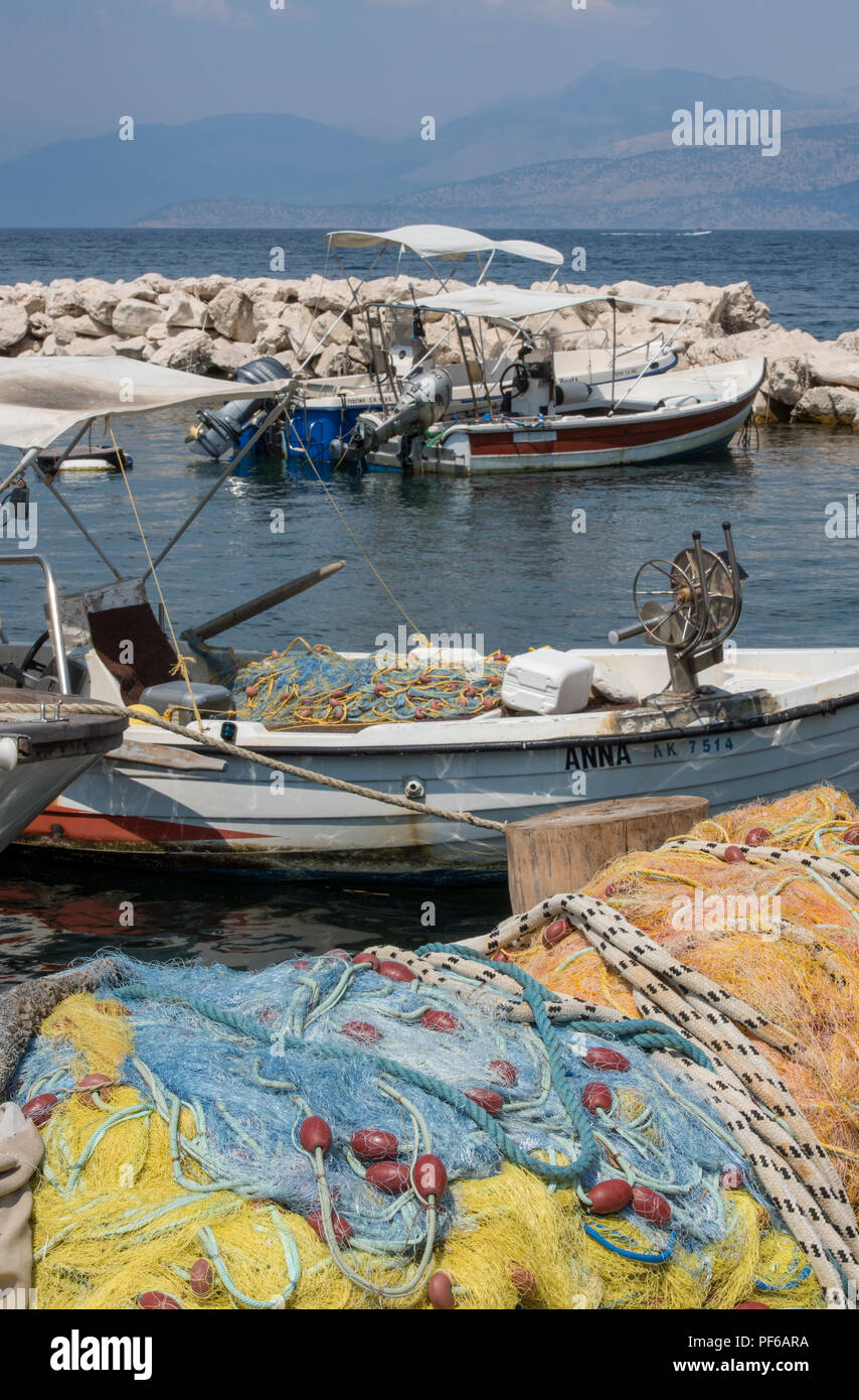 fishing boats and fishing nets at kassiopi harbour on the north east coast of corfu , greece. Stock Photo