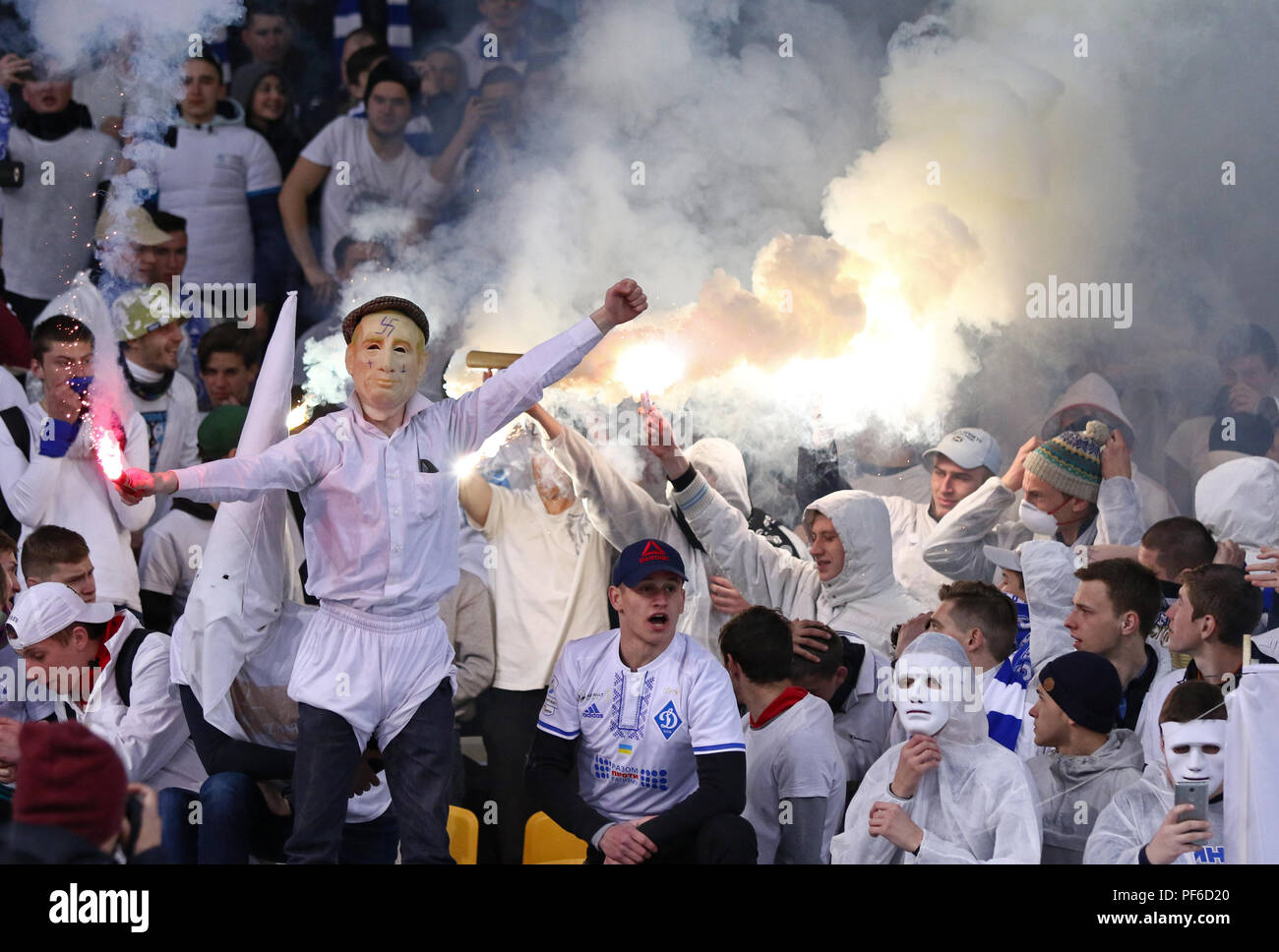 KYIV, UKRAINE - APRIL 21, 2017: Unidentified FC Dynamo Kyiv supporter wearing Vladimir Putin's mask with nazi symbols performs during Ukrainian Premie Stock Photo