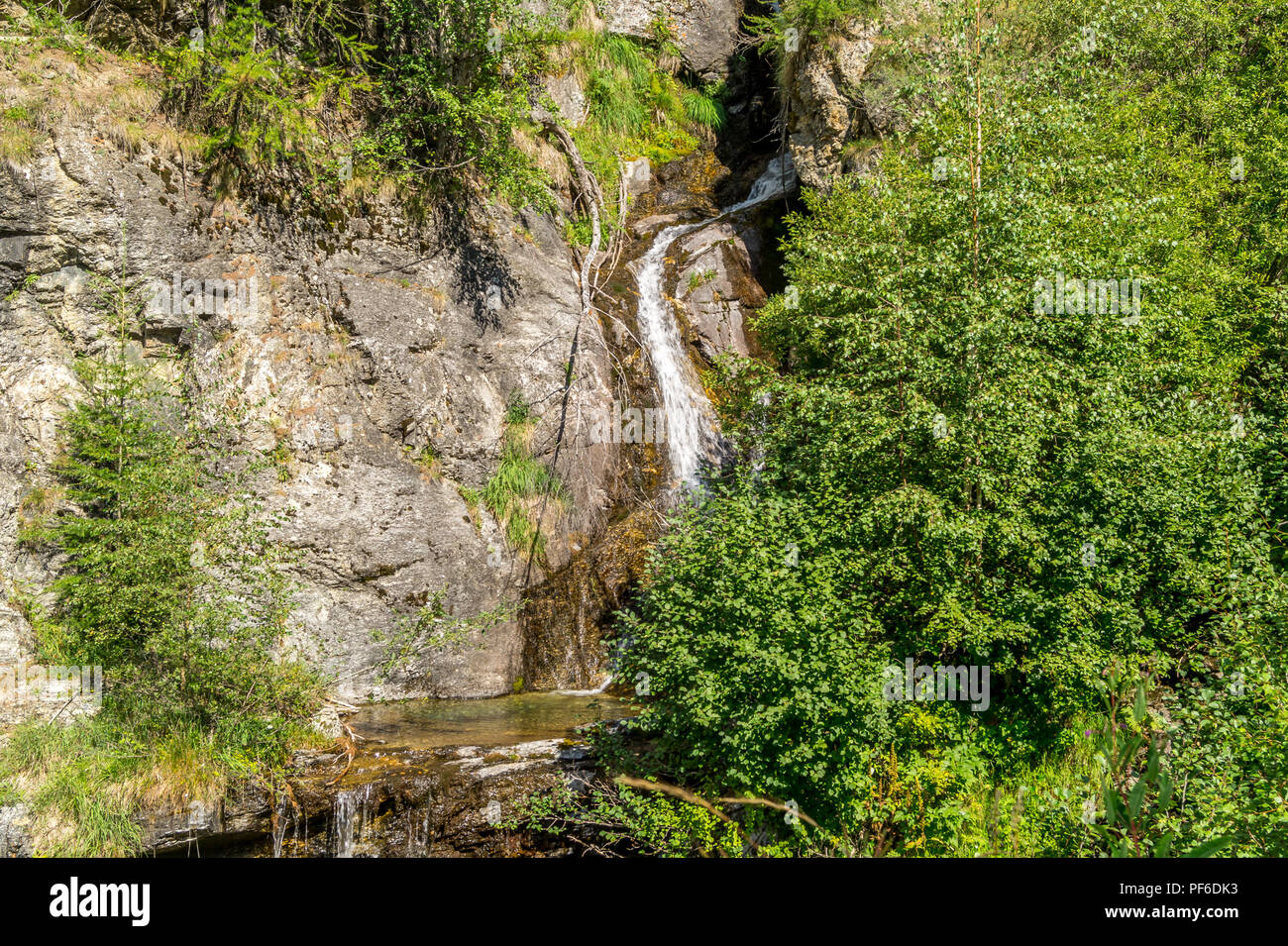 waterfall in the mountains among the rocks Stock Photo - Alamy