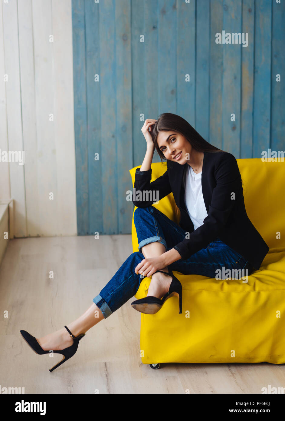 Blue wall woman home sofa hi-res stock photography and images - Alamy