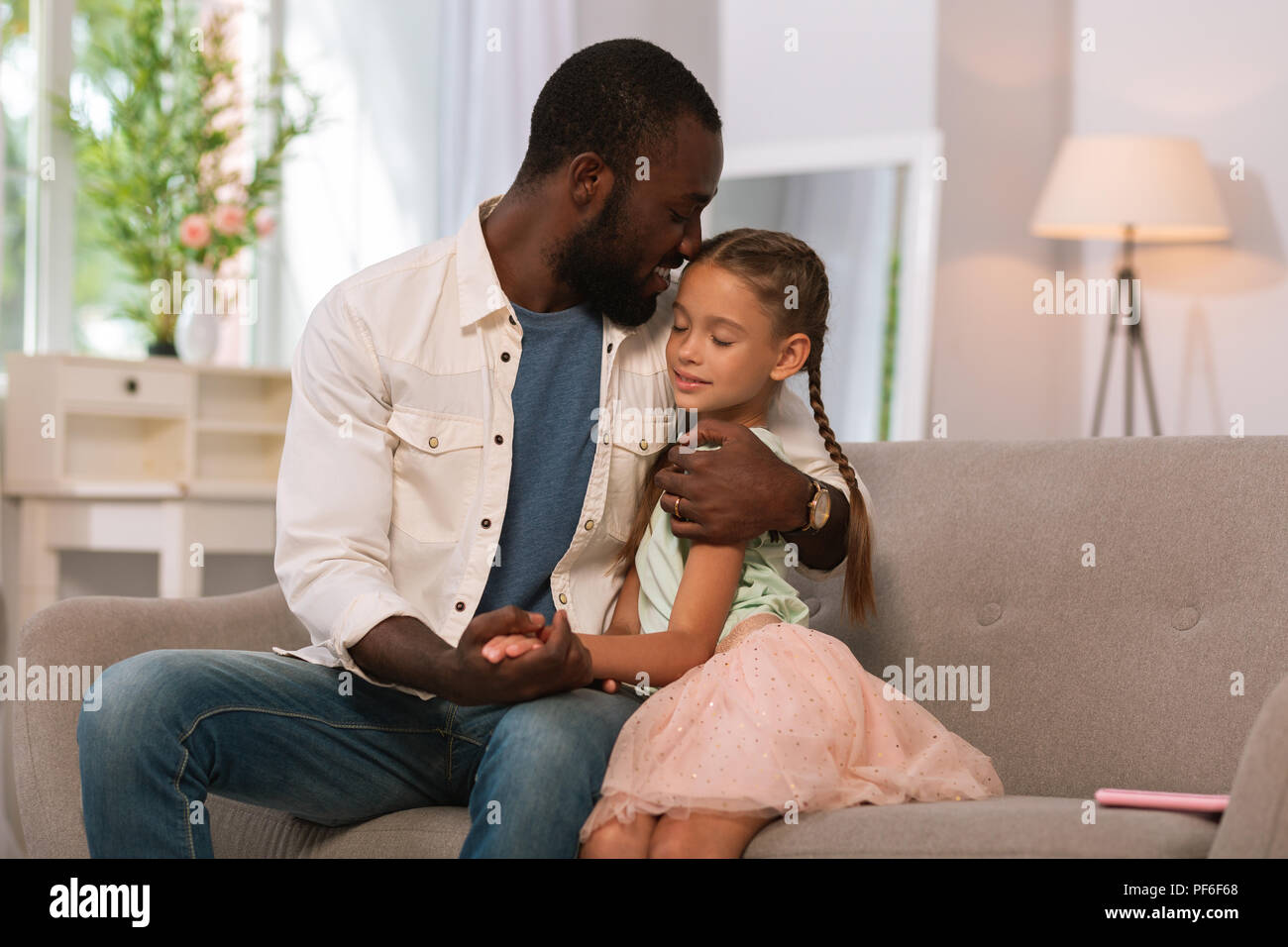 Joyful caring father hugging his child with love Stock Photo - Alamy