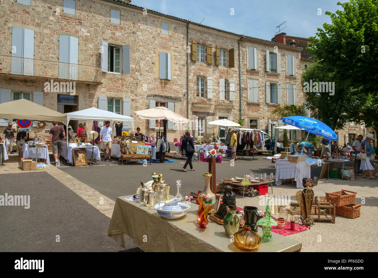 Penne d'Agenais, France - 24th June 2018: Plenty of people come out on a sunny Sunday morning to inspect the stalls at the flea market and table-top sale in picturesque hilltop Penne d'Agenais, Lot et Garonne, France Stock Photo