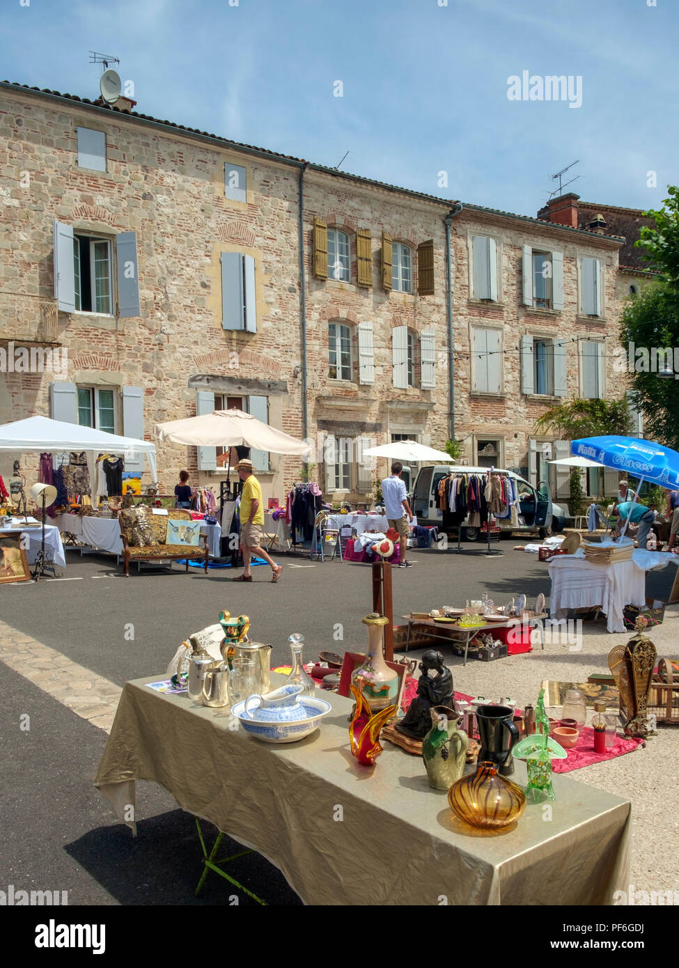 Penne d'Agenais, France - 24th June 2018: Plenty of people come out on a sunny Sunday morning to inspect the stalls at the flea market and table-top sale in picturesque hilltop Penne d'Agenais, Lot et Garonne, France Stock Photo