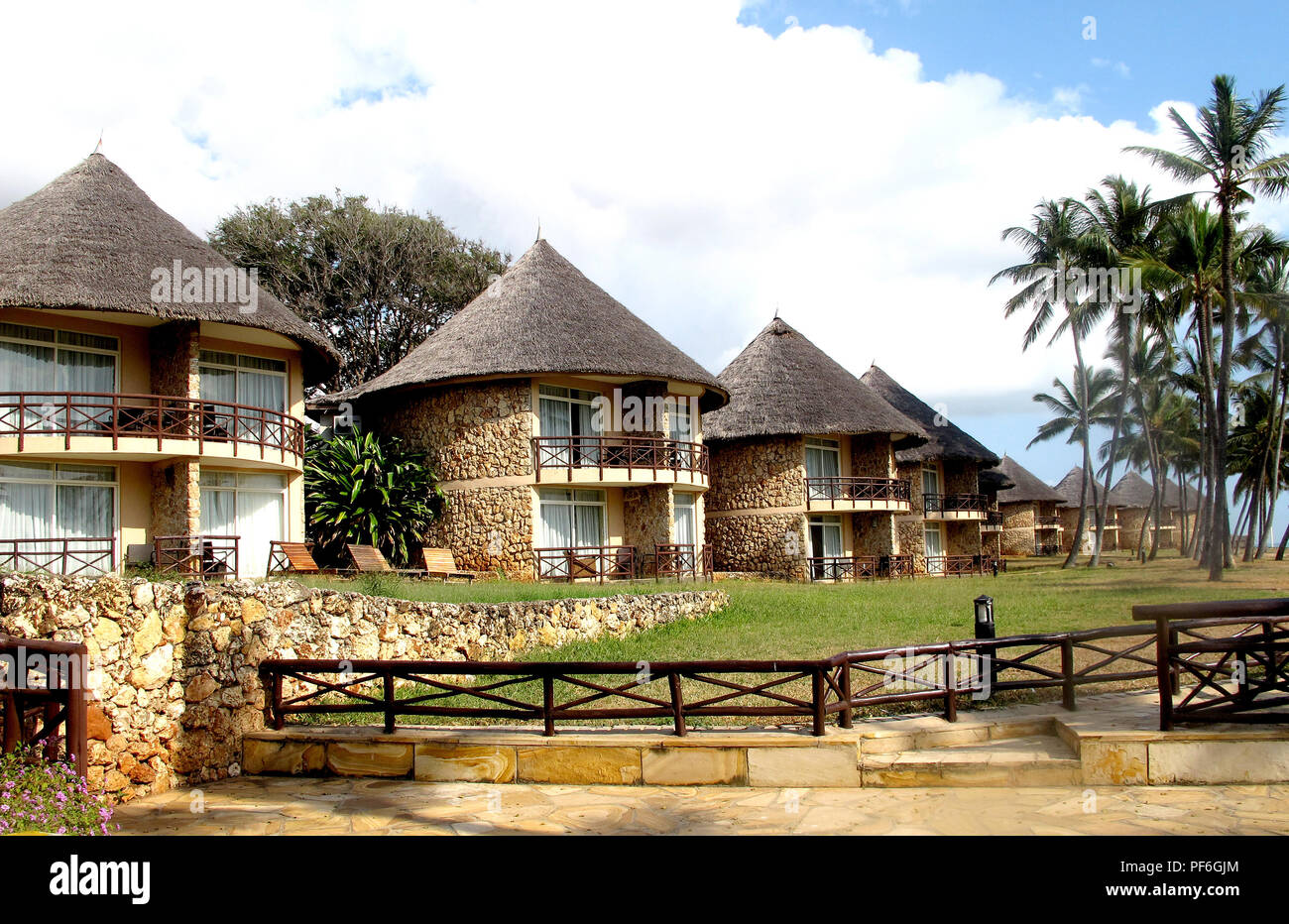 Thatched roof bungalows on the beach of the Crown Plaza Hotel in Dar es Salaam, Tanzania, Africa Stock Photo