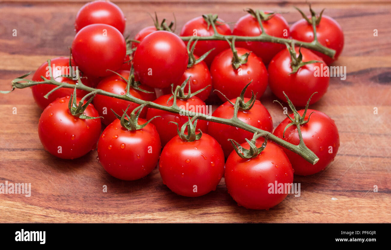 small tomatoes, sherry on a wooden board Stock Photo - Alamy