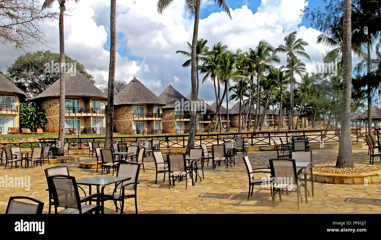 Thatched roof bungalows on the beach of the Crown Plaza Hotel in Dar es Salaam, Tanzania, Africa Stock Photo