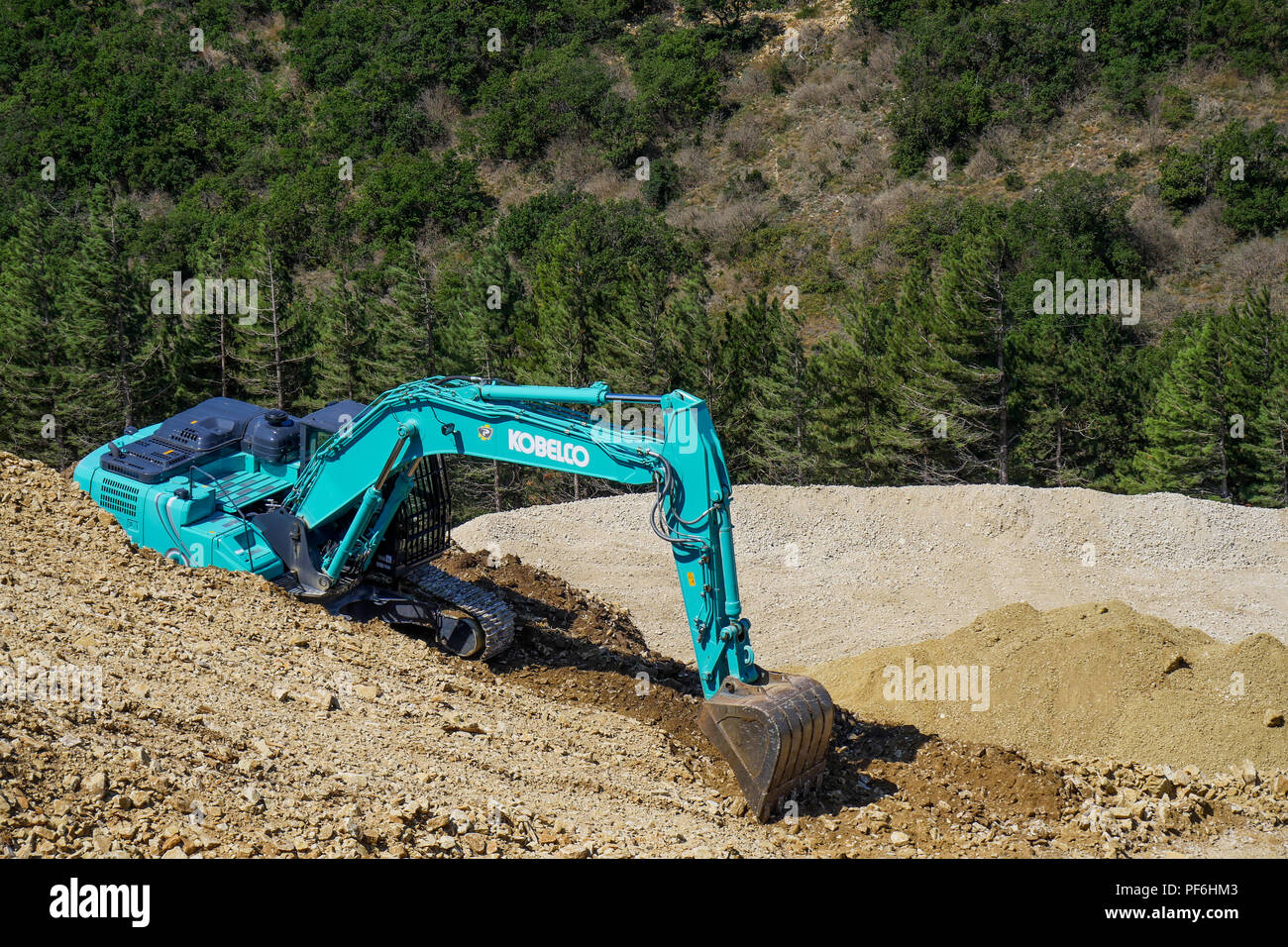 Excavator in a Stone quarry, Eyzahut, Drome, France Stock Photo
