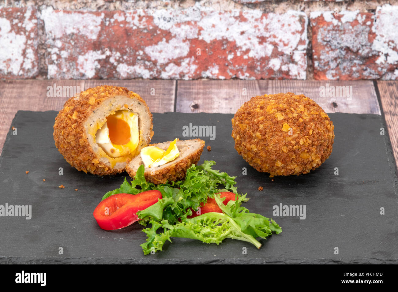 Two runny scotch eggs Stock Photo - Alamy