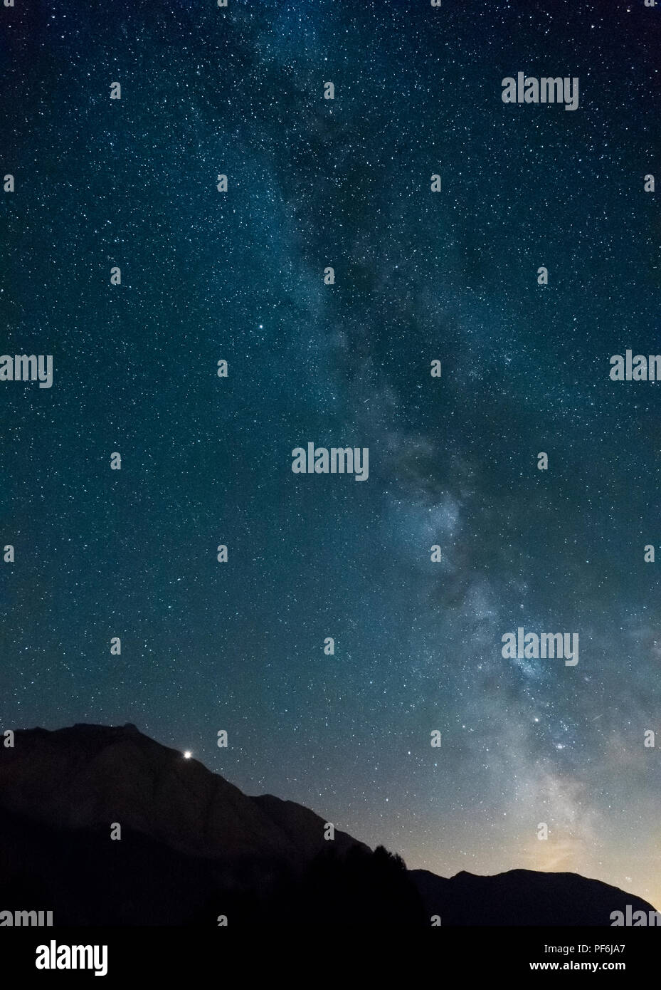 Milky Way with Mars rising behind the mountain, Zuoz, Engadine, Switzerland Stock Photo