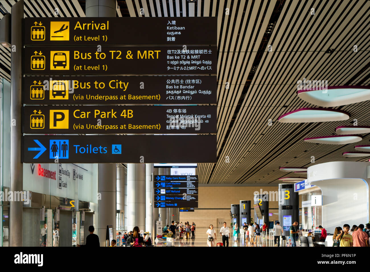 Singapore Julyy 14, 2018 Visitors walk around Departure Hall in Changi Airport. It has 4 Singapore Julyy 14, 2018 Visitors walk around Departure Hall in Changi Airport. It has 4