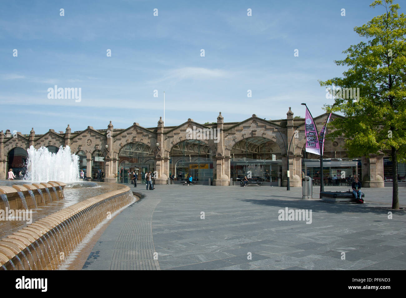 The modern Sheffield Interchange bus station in 2018 with its large fountain water feature and large paved pavement area for travellers and visitors Stock Photo