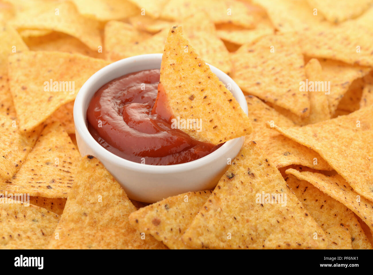 Close up of nacho chips and tomato dip sauce Stock Photo