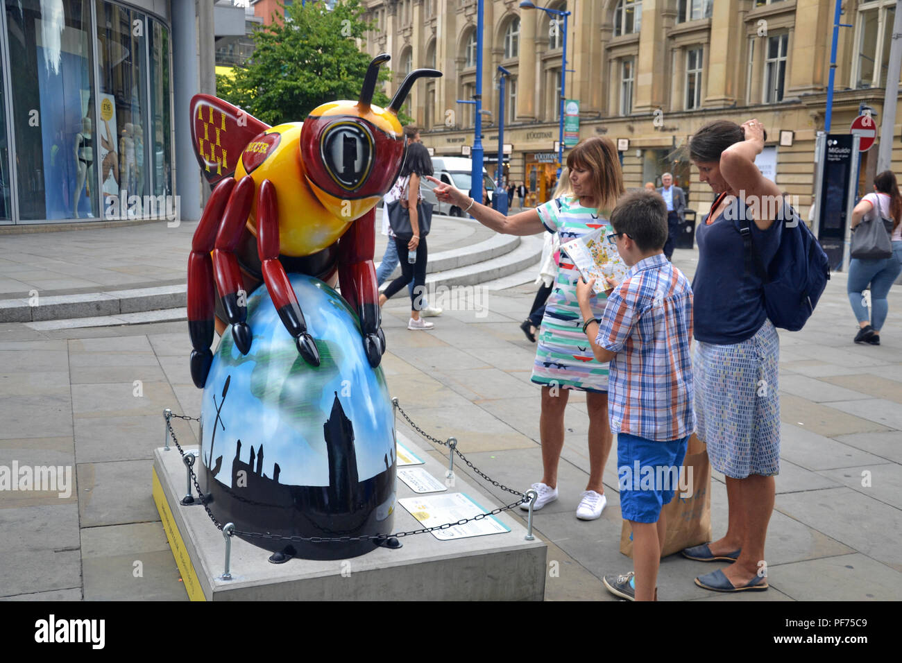 Manchester UK, 20 August, 2018. People in Manchester explore the 'Bee in the City' free, family-fun trail. Over 100 Bees are in the trail which ends 23 September. Credit: Terry Waller/Alamy Live News Stock Photo