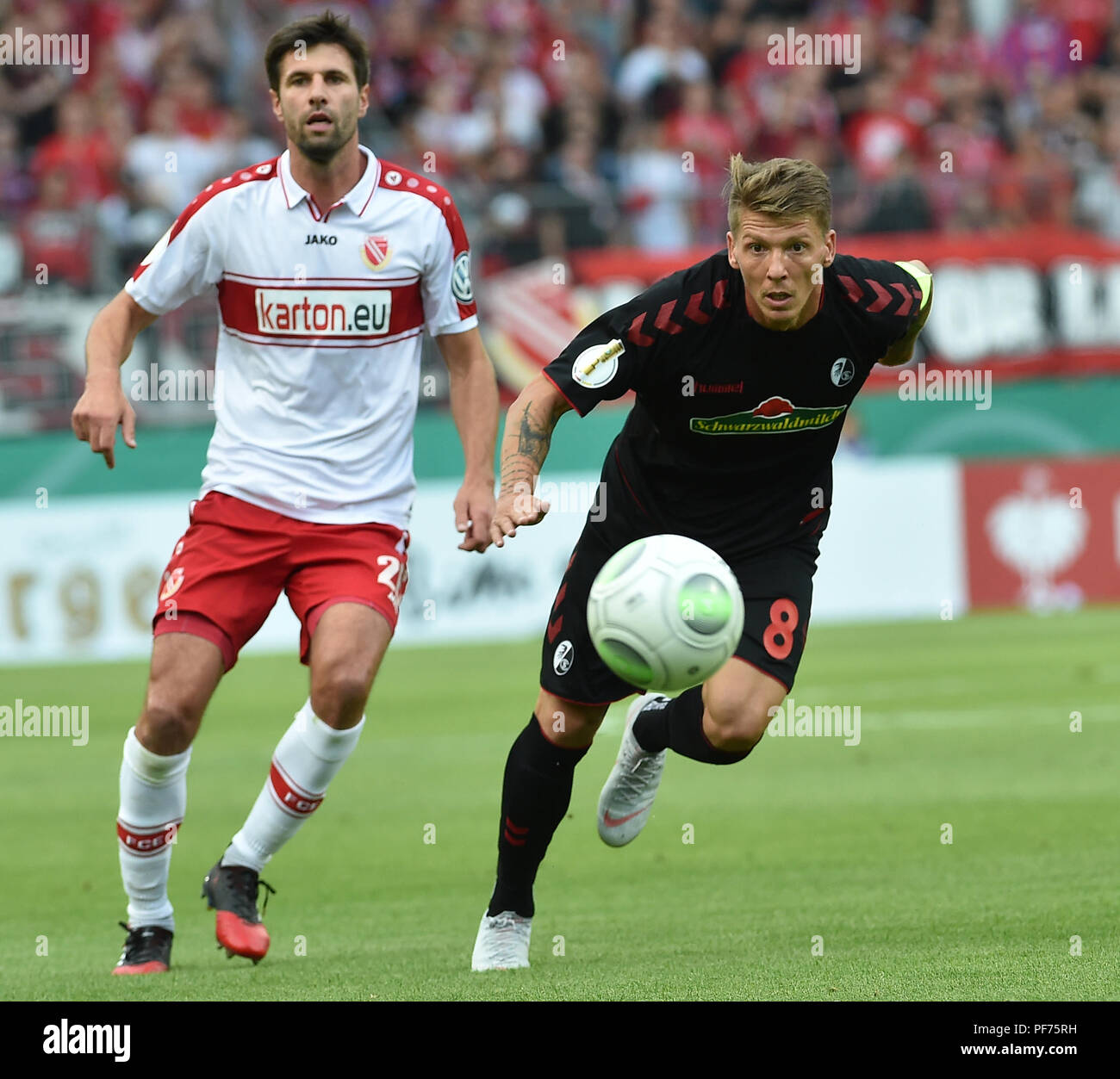Cottbus, Germany. 20th August 2018. Soccer, DFB Cup, Energie Cottbus vs SC Freiburg, 1st round in the Stadion der Freundschaft: Mike Frantz (r) from Freiburg wins against Tim Kruse from Cottbus. Photo: Bernd Settnik/dpa-Znteralbild/dpa Credit: dpa picture alliance/Alamy Live News Credit: dpa picture alliance/Alamy Live News Stock Photo