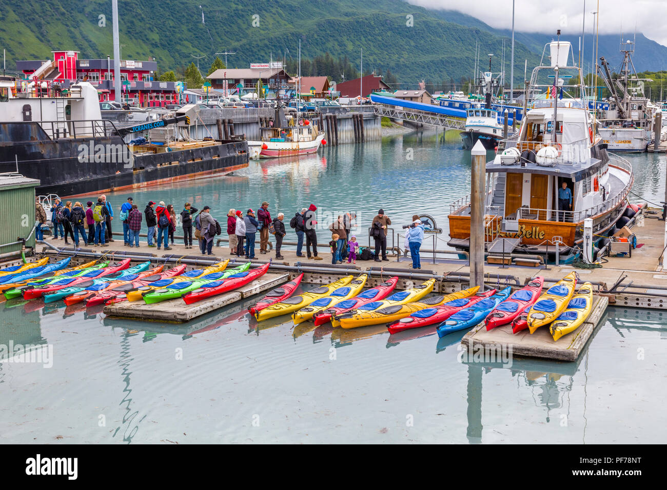 People lined up on dock for glacier boat tour in Valdez Alaska Stock Photo