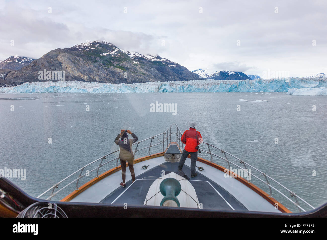 Tourists viewing Columbia Glacier from front of Lu Lu Belle glacier tour boat in Prince William Sound near Valdez Alaska Stock Photo
