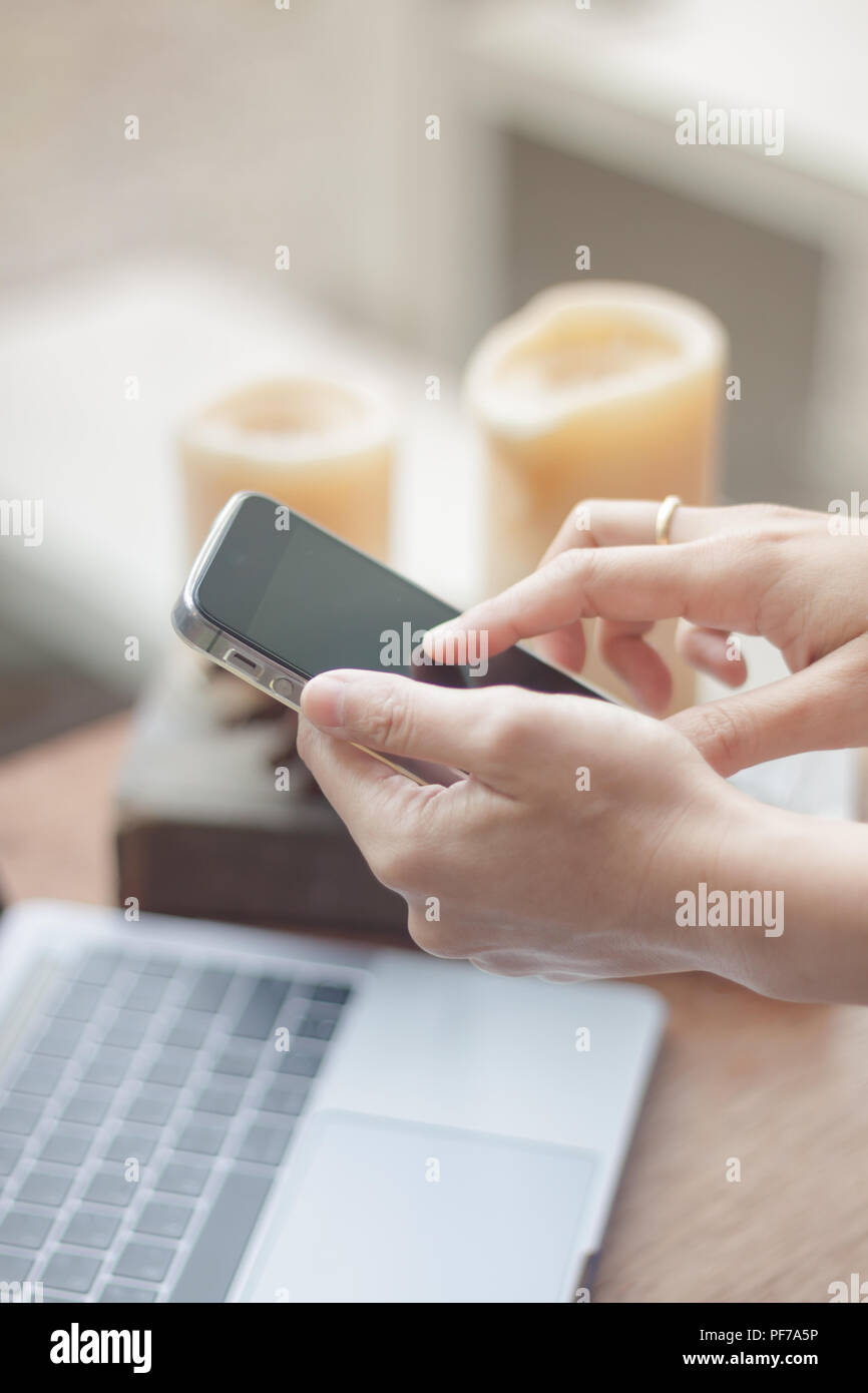 Woman using smart phone in coffee shop, stock photo Stock Photo