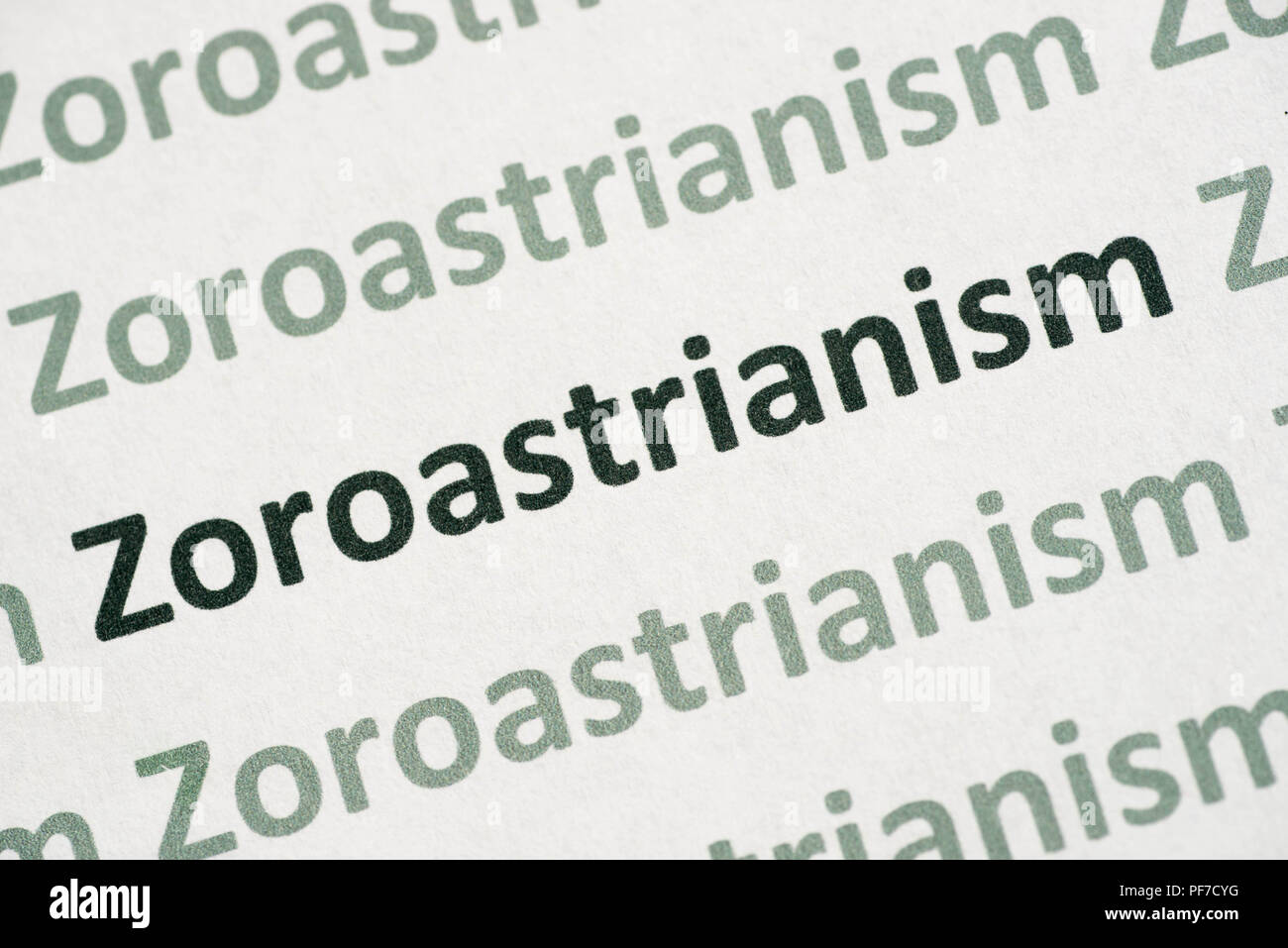 word Zoroastrianism printed on white paper macro Stock Photo