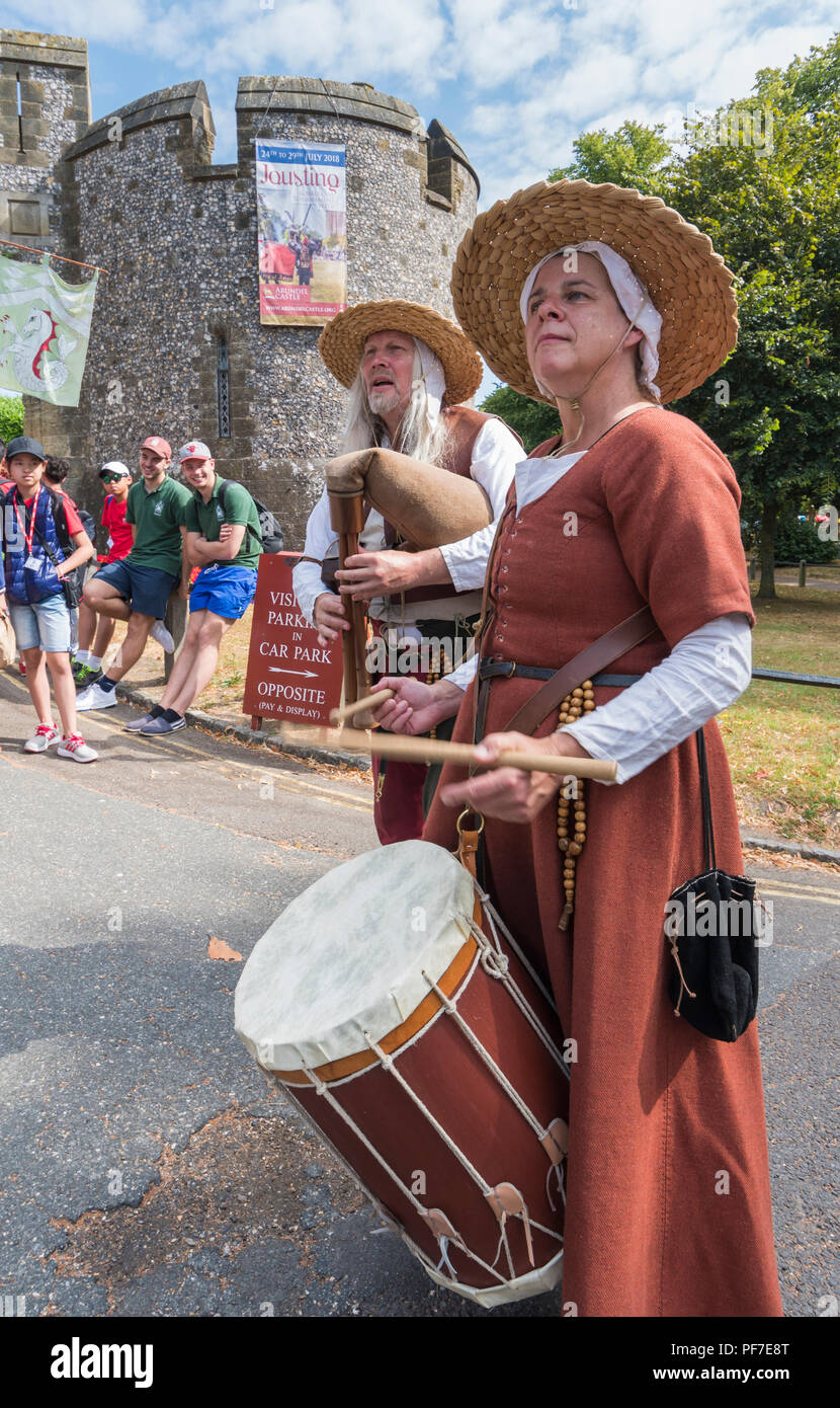People playing drums dressed in medieval period costumes. Medieval street musicians in Arundel, West Sussex, England, UK. Stock Photo